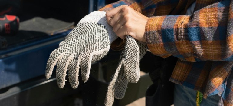 A close-up of safety gloves used for professional piano moving.