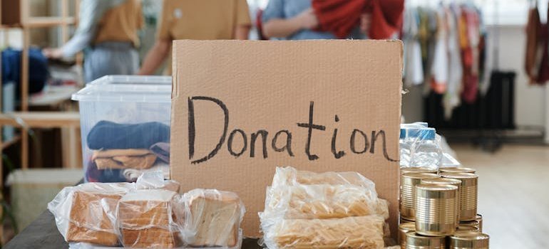 a donation sign in front of a box of donated items, moving from Frederick to Ashburn