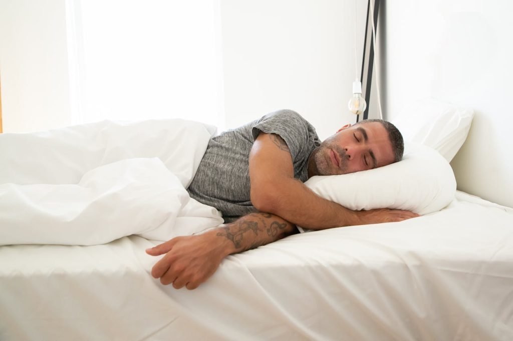 Man in Gray Shirt Lying on the Bed and trying to Keep Familiar Routines While Moving Locally