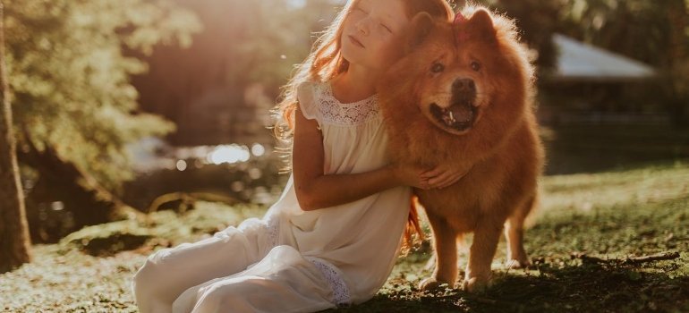 Child hugging a dog