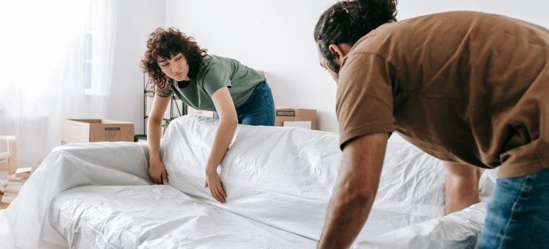 Couple lifting a couch