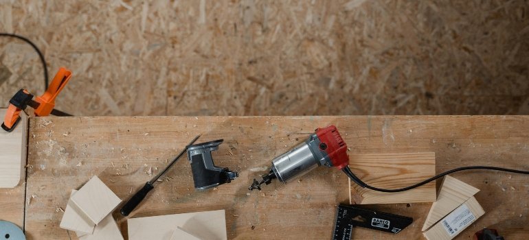 A set of woodworking tools and wood pieces on a workbench, representing minor upgrades before listing an apartment.