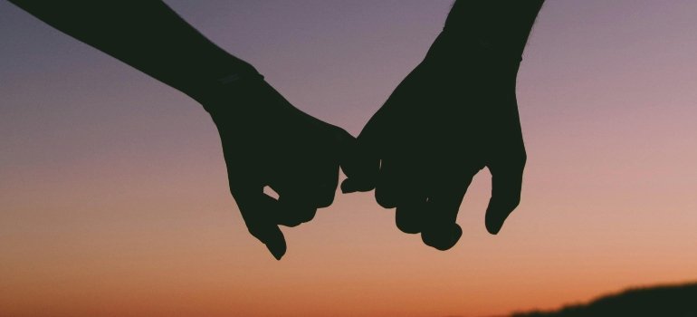 A couple is holding hands.