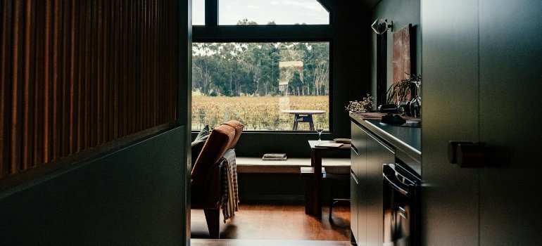 A modern room with a large window overlooking a vineyard, showing peaceful living for those who Live Comfortably in Maryland.