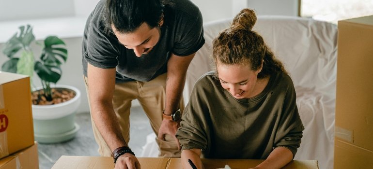 a girl and a boy writing something during relocation