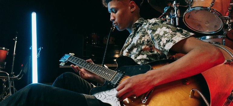 a young man playing guitar