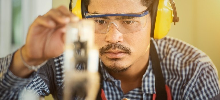 a man with working glasses packing things
