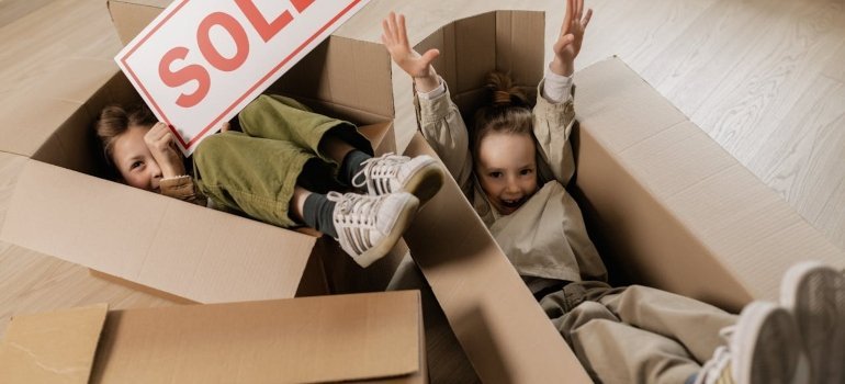 Kids in boxes holding a sign