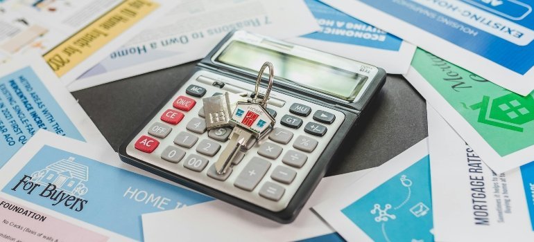 Keys on a calculator resting on mortgage papers, hinting at the serious math behind home buying.