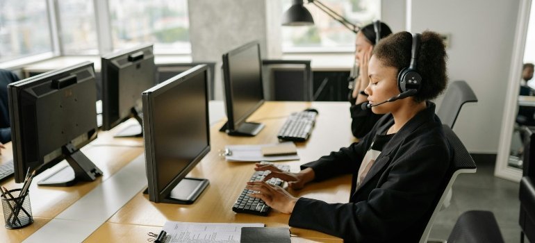 Support agents work at their desks while helping customers with storage questions.