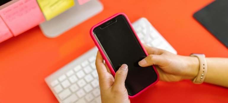 A Person Holding a Smartphone A Person Holding a Black Cellphone