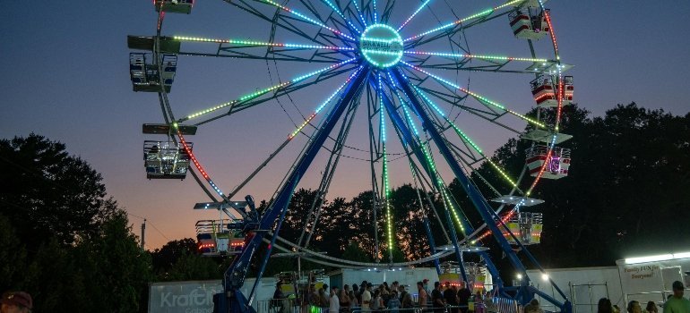 Vibrant Ferris wheel lit up at night, representing Virginia’s lively seasonal fairs and community events