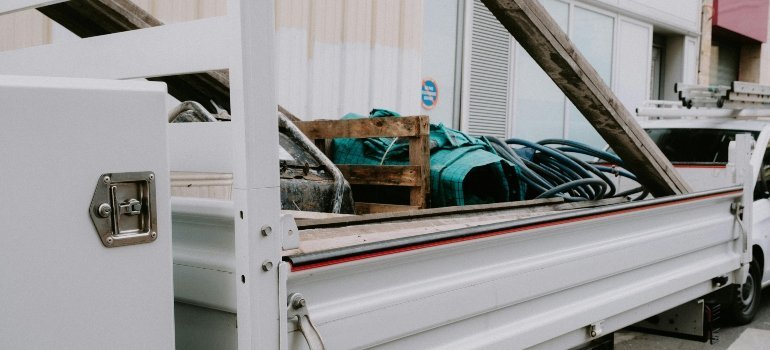 Best equipment for moving heavy furniture shown with a white moving truck parked on a city street in Washington DC