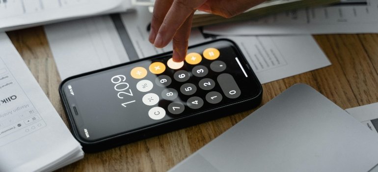 A Man with Wedding Ring Computing with a Mobile App Calculator