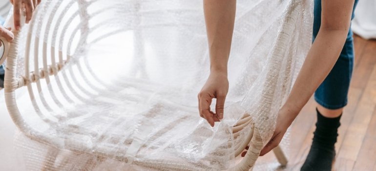 Person unwrapping furniture