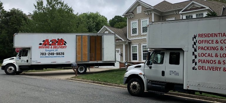 Professional moving trucks set up for military relocation in Washington DC neighborhood