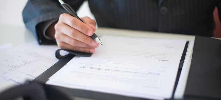 Person signing a contract.