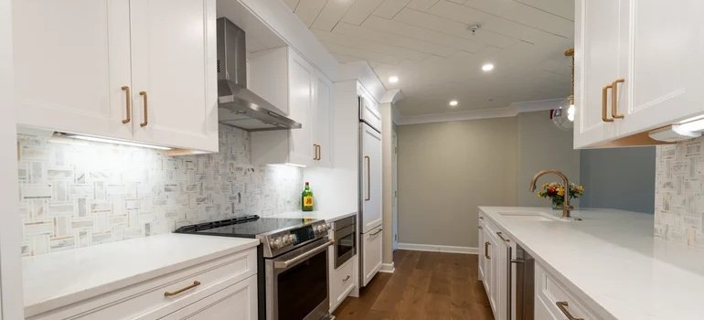 Remodeled kitchen, one of the better home improvements, with white cabinets.