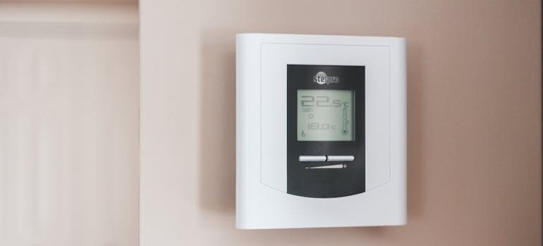 Smart thermostat on a wall.