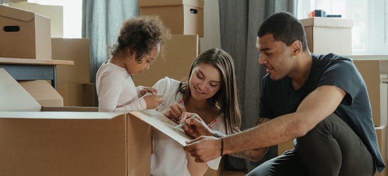 Parents labeling boxes with their daughter before moving from Northern Virginia to Maryland.