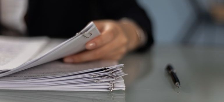 Person looking at documents and their after moving checklist.