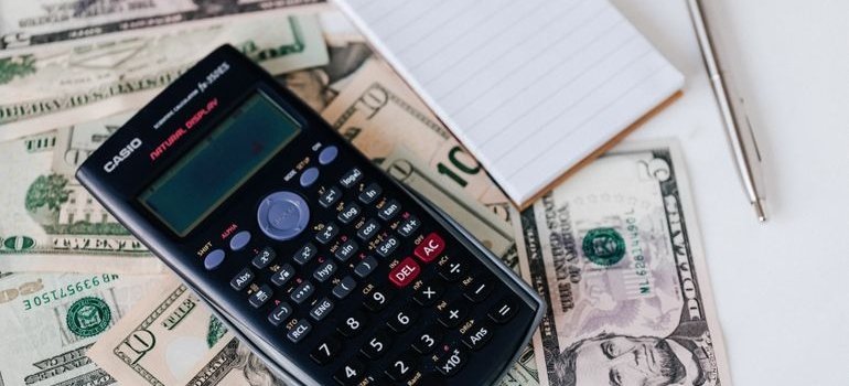 Calculator and notepad used to research cheapest states to live in.