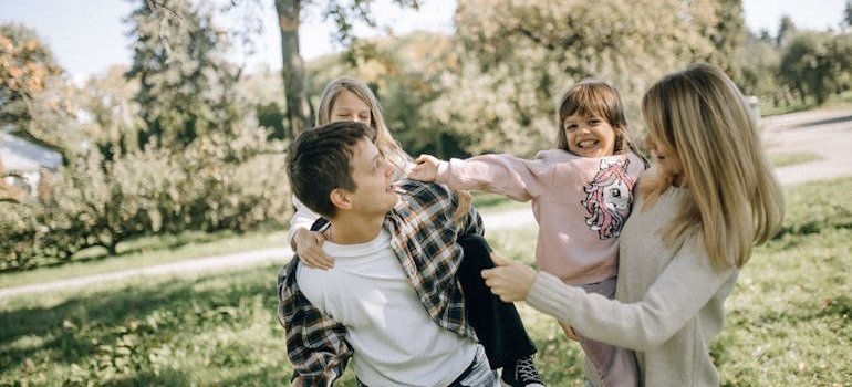 Parents enjoying the day in the park with their children after moving from Northern Virginia to Maryland.