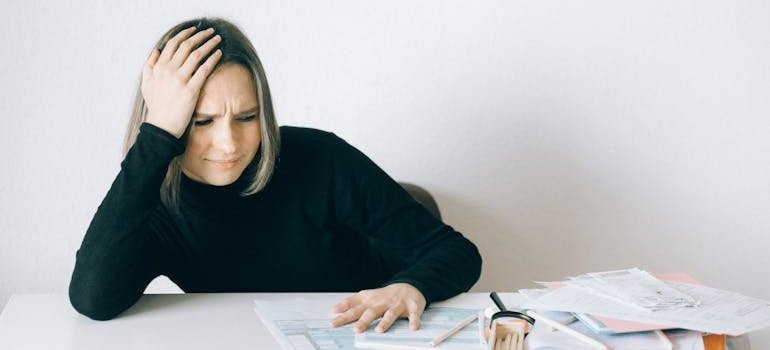 Woman looking at bills and worrying.